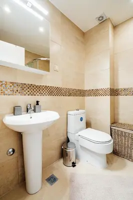 a bathroom with a white toilet and a sink at Przno Apartments by In Property in Pržno