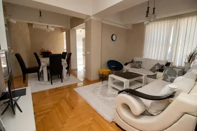 a living room with a white couch and a table at APARTMENTS ANI in Ulcinj