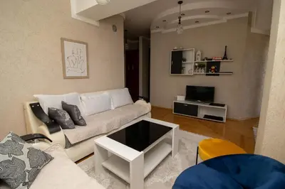 a living room with a couch and a tv at APARTMENTS ANI in Ulcinj