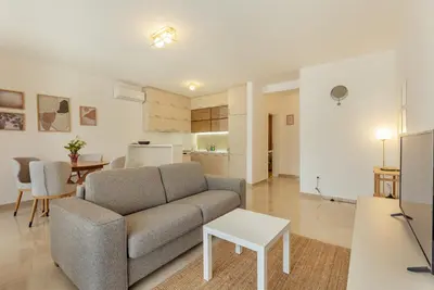 a living room with a couch and a table at Apartment Throne in Kotor