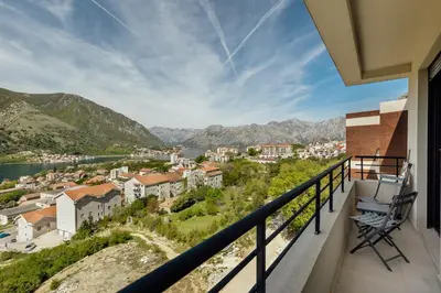 a balcony with a view of a city and water at Apartment Throne in Kotor
