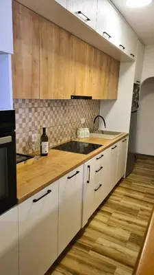 a kitchen with white cabinets and a sink at Boka apartment in Kotor
