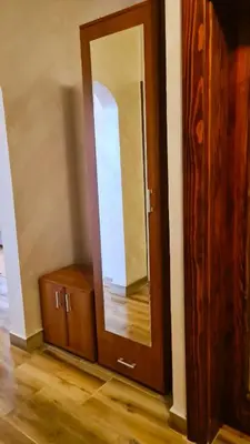 a mirror and a wooden cabinet in a room at Boka apartment in Kotor