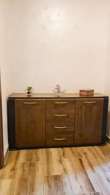 a large wooden cabinet with two plants on top of it at Boka apartment in Kotor