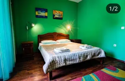 a green bedroom with a bed and a green wall at Apartmen Donji Stoj in Donji Štoj