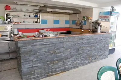 a kitchen with a stone counter in a kitchen at Apartmen Donji Stoj in Donji Štoj