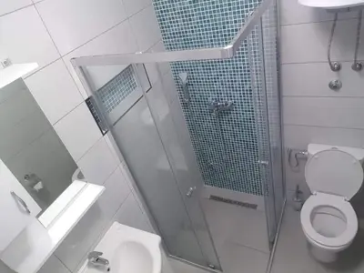 a bathroom with a shower with a toilet and a sink at Bulat 1 in Budva