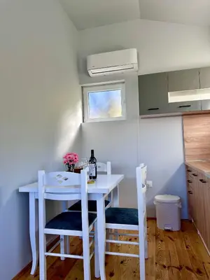 a white table and chairs in a small kitchen at Tina in Cetinje
