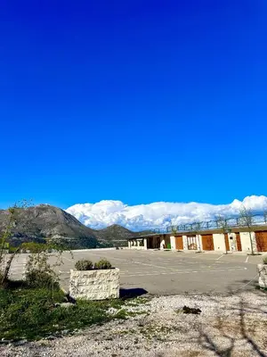 an empty parking lot with mountains in the background at Tina in Cetinje