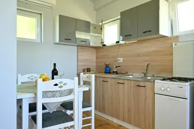 a small kitchen with a sink and a counter at Tina in Cetinje