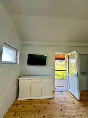 an empty room with a tv and a white cabinet at Tina in Cetinje
