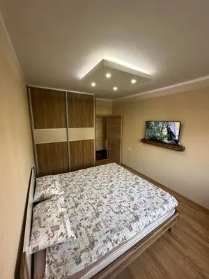 a bedroom with a bed and a tv on the wall at SARA in Ðuranovići