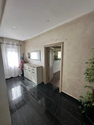 a person standing in a kitchen with a window at SARA in Ðuranovići