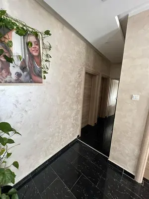 a hallway with a wall with pictures on it at SARA in Ðuranovići