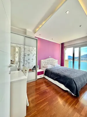 a bedroom with a large bed and a sink at Ponta Nova One bedroom Apartment with Sea view in Budva