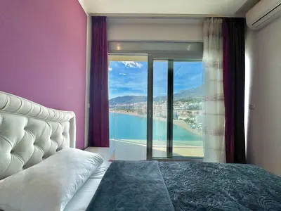 a bedroom with a bed and a view of the water at Ponta Nova One bedroom Apartment with Sea view in Budva