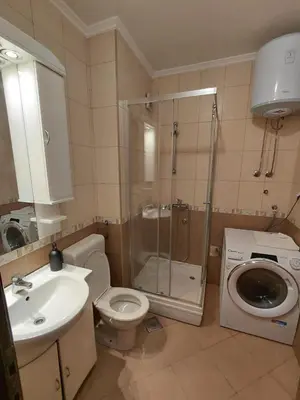 a bathroom with a shower and a toilet and a sink at Luna Apartman in Kotor