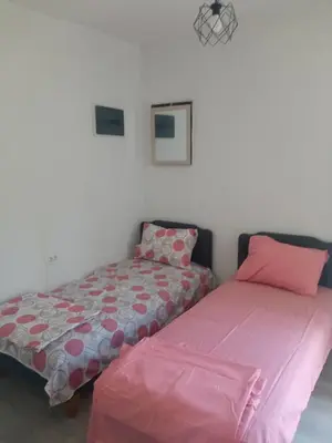 two beds sitting next to each other in a room at Mara in Podgorica