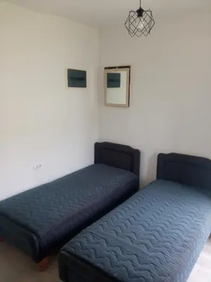 two beds sitting next to each other in a room at Mara in Podgorica