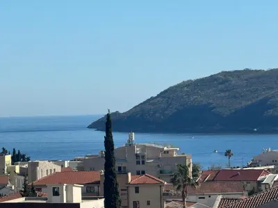 a city with buildings and the ocean in the background at MBD apartment Budva in Budva