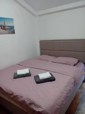 a bedroom with a bed with two towels on it at MBD apartment Budva in Budva