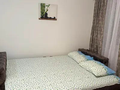 a bed with two pillows on it in a room at MBD apartment Budva in Budva