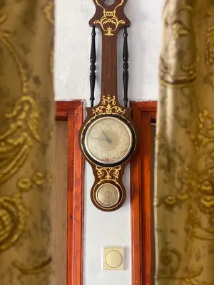 a grandfather clock is hanging on a wall at Rijeka crnojevica in Cetinje