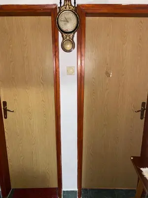 an open door with a clock on the wall at Rijeka crnojevica in Cetinje