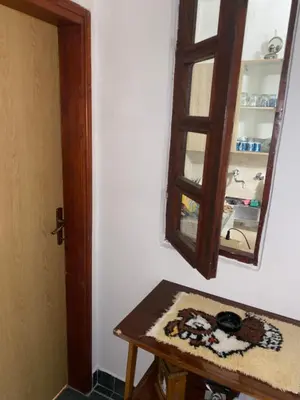 a mirror sitting on a wall next to a table at Rijeka crnojevica in Cetinje