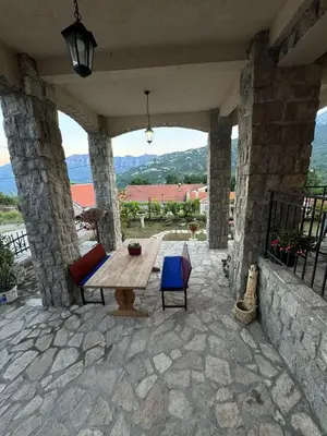 a table and chairs on a patio with a view at Villagio in Virpazar