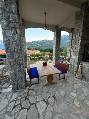 a table and chairs on a patio with a view at Villagio in Virpazar