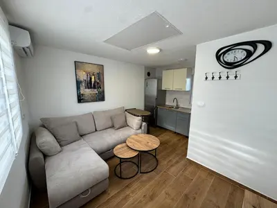 a living room with a couch and a table at Villagio in Virpazar