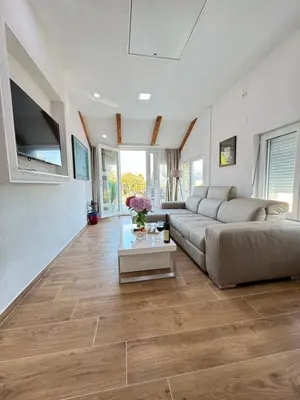 a living room with a couch and a table at Villagio in Virpazar