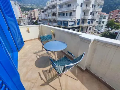 a table and chairs on a balcony with a view at Glory Suites in Budva