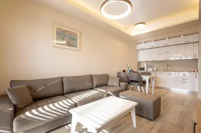 a living room with a couch and a table at La Vista Apartment in Petrovac na Moru