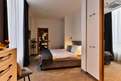 a hotel room with a bed and a mirror at Hotel Boka in Kotor