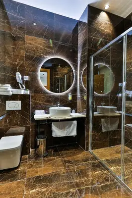 a bathroom with two sinks and two mirrors at Hotel Boka in Kotor