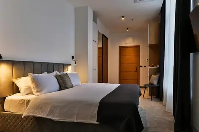 a bedroom with a large bed with white pillows at Hotel Boka in Kotor