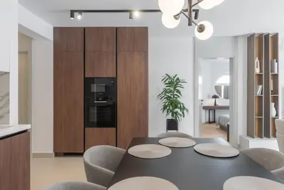 a kitchen and dining room with a table and chairs at Vista Premium Apartment in Kotor