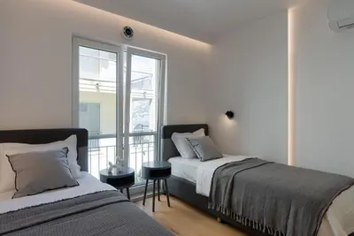 a bedroom with two beds and a window at Vista Premium Apartment in Kotor