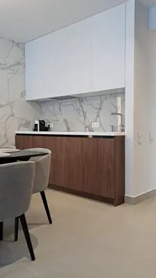 a kitchen with a counter and a table and chairs at Vista Premium Apartment in Kotor