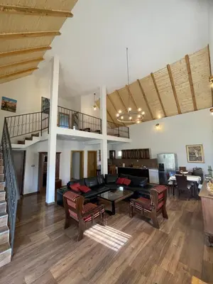 a living room with a couch and a table at Holiday House Korita in Podgorica