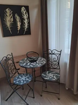 two chairs and a table and a table and two chairs at Holiday Home Apartment in Budva
