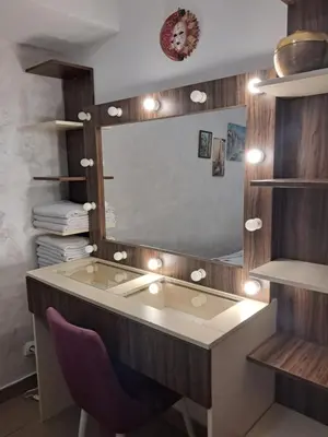 a dressing room with a mirror and a purple chair at Holiday Home Apartment in Budva