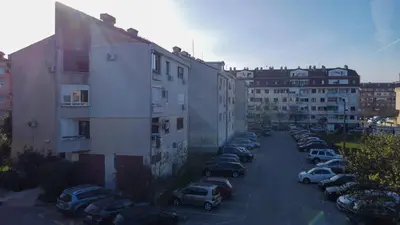 a parking lot with cars parked next to buildings at Apartment Kosta in Podgorica