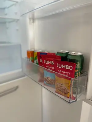 a refrigerator shelf with some food in it at Listik Apartments in Becici
