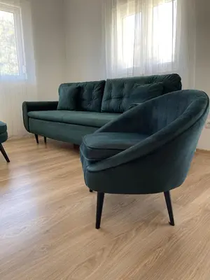 a green couch sitting in a living room at Listik Apartments in Becici