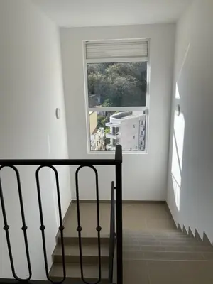 a staircase in a white room with a window at Listik Apartments in Becici