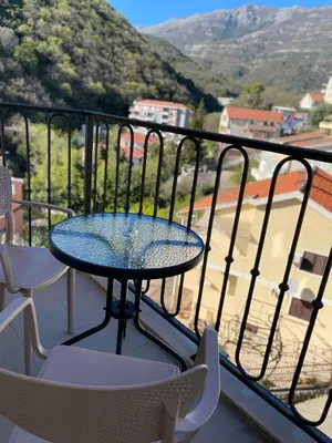 a table and chairs on a balcony with a view at Listik Apartments in Becici