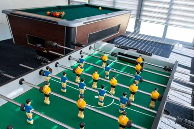a group of men standing on a pool table at Vila Apartmani Astoria in Podgorica